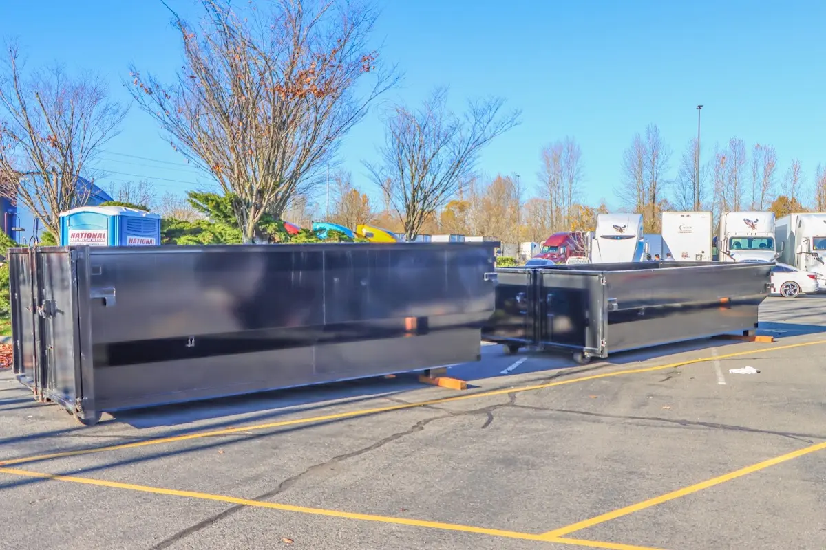 Professional dumpster rental service with roll-off container on residential driveway in Harborcreek